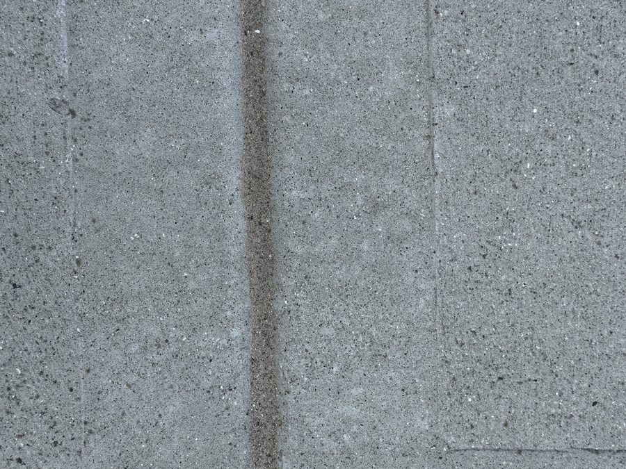 Driveway expansion joint cleanly sealed with proprietary compound