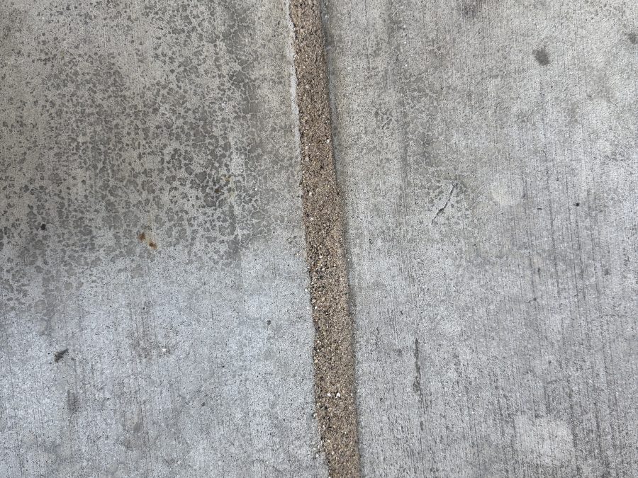 Sealed expansion joint color-matched and blended with the concrete