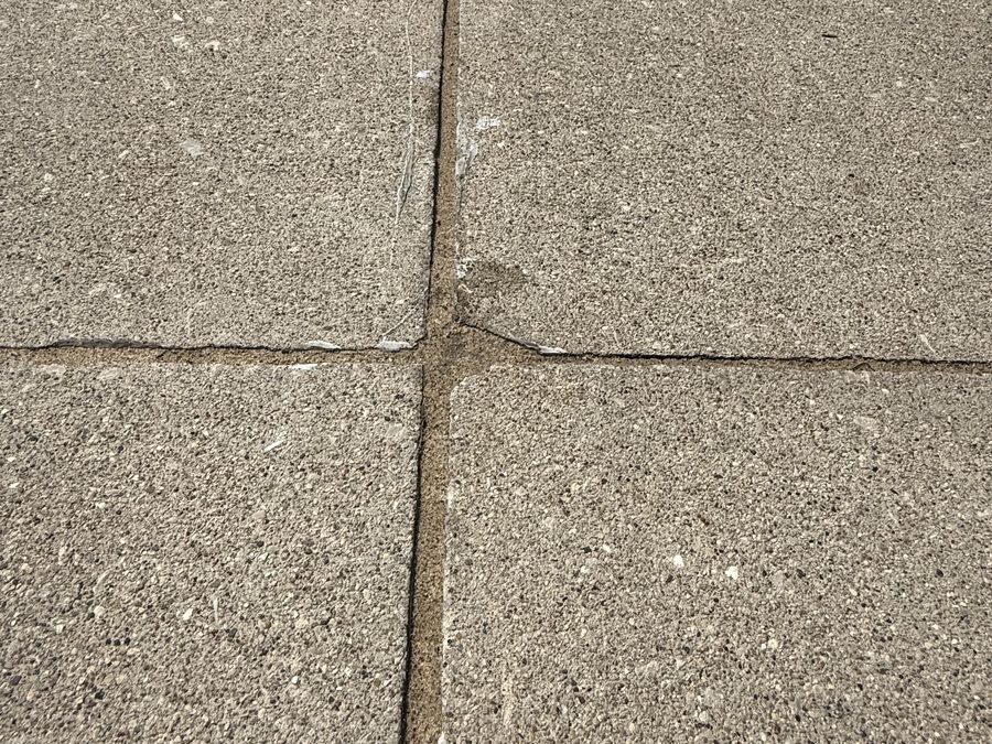 Freshly sealed expansion joint on an Oklahoma City-area driveway