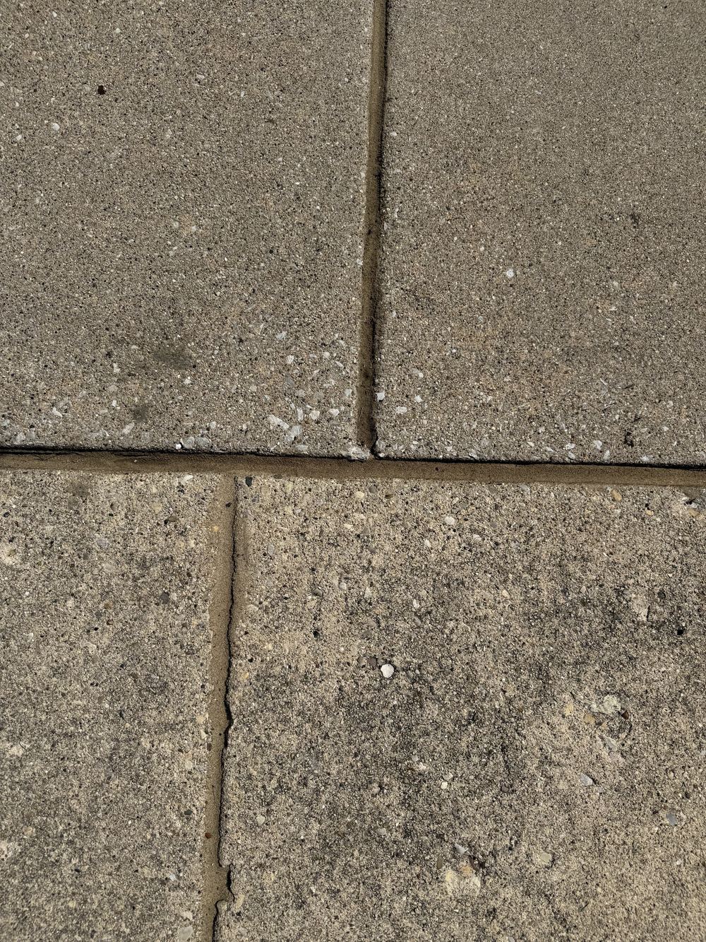 Sealed intersecting driveway joints filled clean where multiple slabs meet